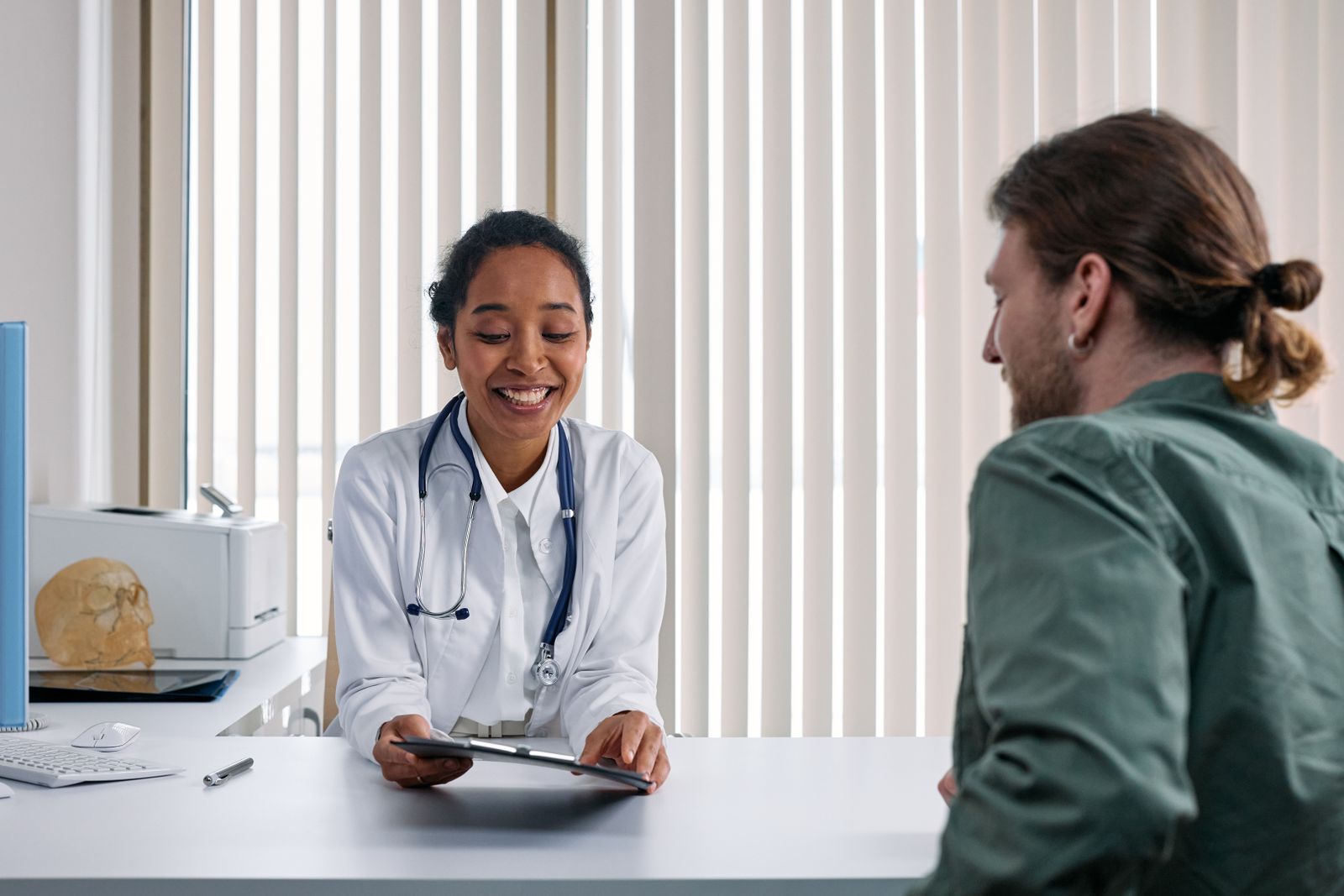 A caregiver talking with their doctor at a checkup, the appointment so many caregivers skip for themselves