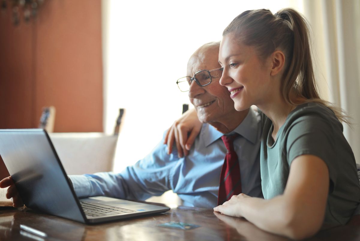 An adult child helping an older parent review Medicare options together at home