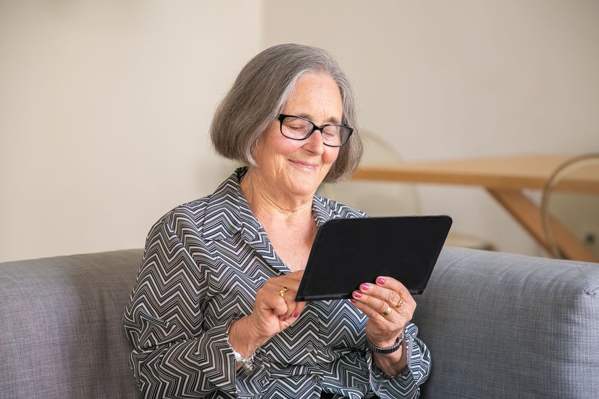 An older woman comfortable and independent at home, the kind of daily life smart home devices can help protect